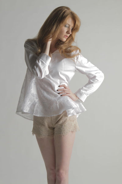 A TRENDY PEPLUM TOP WITH A TWIST. THIS  UNFILTED BLOUSE FEATURES  ASSYMETRICAL PEPLUM.